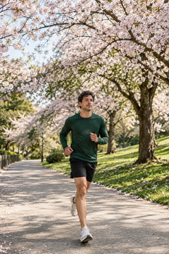 Runner on a spring path under cherry blossoms
