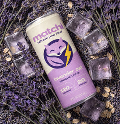 A Matchi Lavender Oat can lying on dried lavender with ice cubes