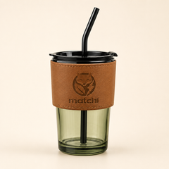 MATCHI Ritual Glass Cup: matcha-tinted glass cup with vegan leather sleeve, black lid and reusable straw